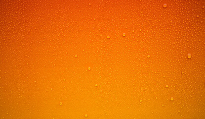 Round raindrops on an orange background. Photo of an orange texture with water droplets. Yellow...