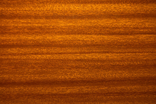 Photo of a vintage-style mahogany texture. The wooden background is red.Veneer surface for internal and external use of manufacturers.