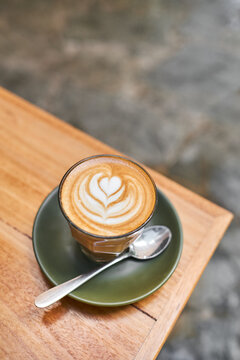 Latte on a green saucer with latte art