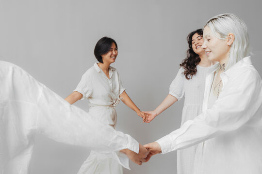 Asian model holding hands with girlfriends