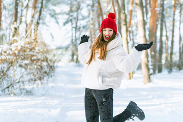 Cheerful brunette girl in winter forest. Portrait in motion.