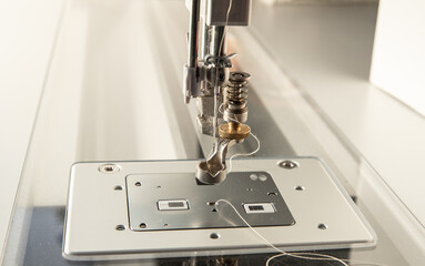 Closeup of a sewing machine presser foot. 