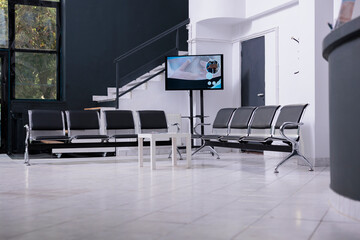 interior of empty hospital lobby with big windows waiting for patients. Modern healthcare facility, professional treatment room. Waiting area of emergency hospital reception