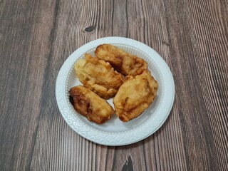 A market snack made from fried bananas wrapped in crispy flour