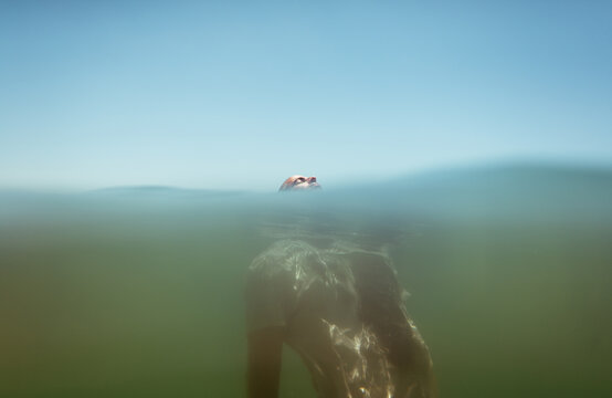 Surrendered  man floating on the sea