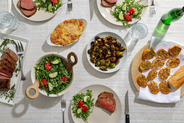 Table covered with food and drinks.