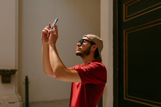 Man taking a picture with smartphone inside a building 