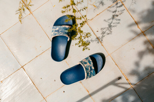  flip-flops on tile floor in sunlight