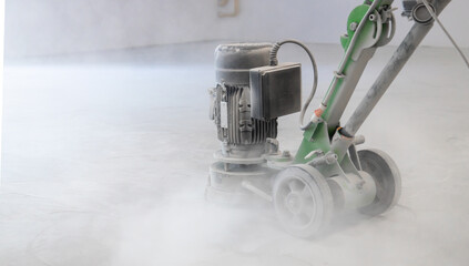 Concrete grinder, industrial equipment at work, concrete floor repair in industrial premises