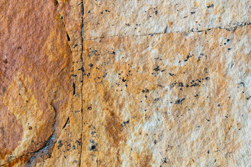 Close-up of sandstone surface for background, cracked stone texture
