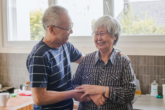 happy smiling mature senior asian couple laughing portrait at home