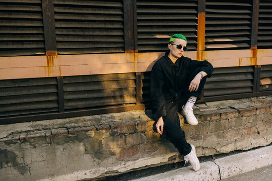 urban portrait of smoking androgyne person 