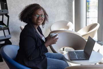 successful smiling business woman portrait looking at camera in cafe