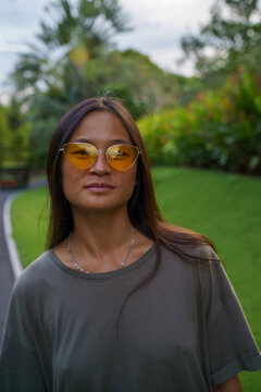 Portrait of Chinese woman with orange sunglases