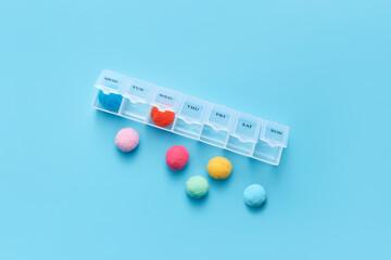 Medicine pill box with multicolored soft balls.