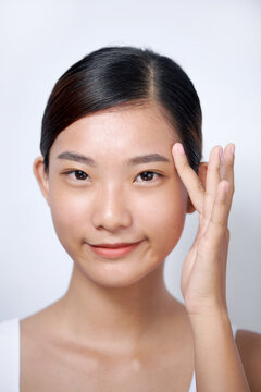 Beautiful young asian woman with clean fresh skin on white background,