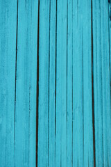 vibrant turquoise painted wood fence in full sun