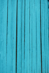 Fototapeta premium vibrant turquoise painted wood fence in full sun