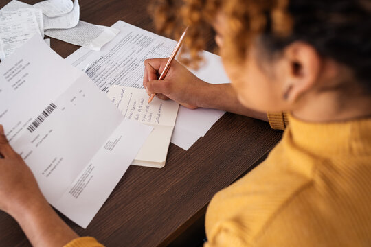 Businesswoman analyzing tax invoice at home