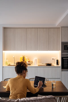 Anonymous businesswoman making investments at home