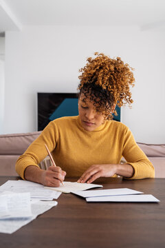 Hispanic accountant making notes during work