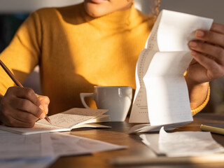 Crop businesswoman analyzing budget at home