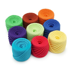 Spools of multi-colored cotton threads on a white background. Cotton yarn in ball and bobbins