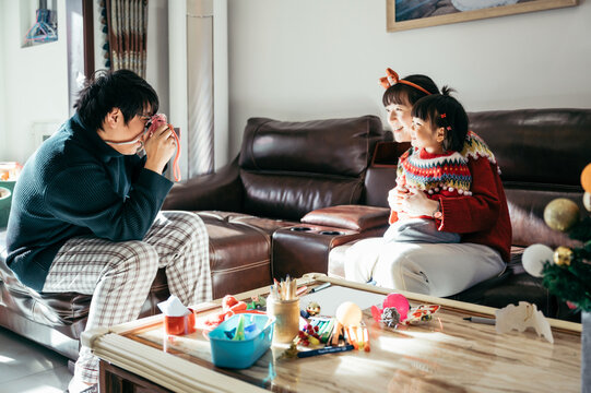 Cute baby girl playing with her parents at home