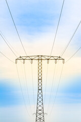 Outdoor Transmission Network Tower / High voltage electricity pylon cable line with yellow shine at blue sky background