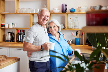 Content elderly couple in kitchen