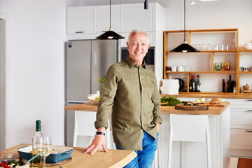 Cheerful senior man in kitchen