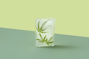 Cannabis leaves frozen in block of ice.