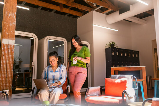 Companions in cowork area with laptop