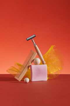 Solid shampoo bar and wooden comb on red background