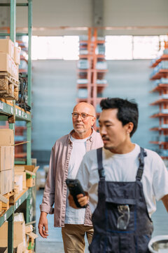 Two Men Working in Factory 