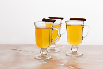 apple cider in a glass on a marble table