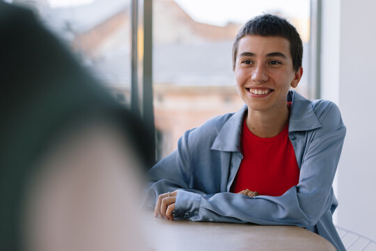 Boyish Girl spending time with friend in cafe