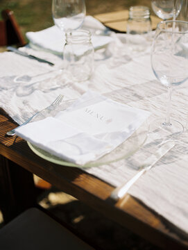 View Of An Event Table With A Plate, Silverware And Glassware On It