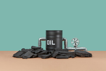 Black oi barrel and pieces of coal.