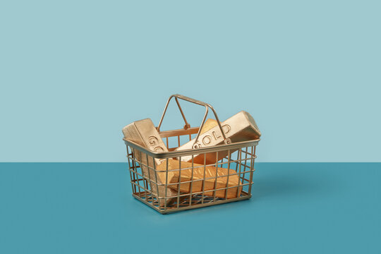 Gold ingots in gilded shopping basket.