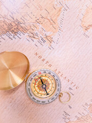 Fototapeta na wymiar Close up of golden compass on vintage map,travel concept,road direction