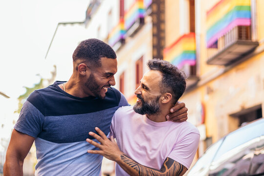 Gay couple walking down the street holding each other