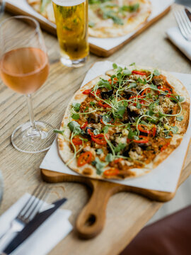 A selection of pizza on a wooden table in a pub