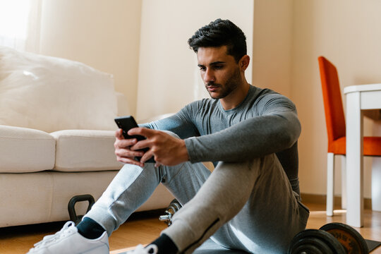 Sportsman texting on cellphone during break