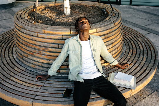 Student relaxing on bench