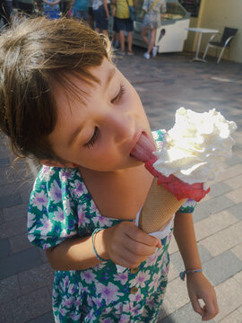 Girl eating ice cream in summer. UGC
