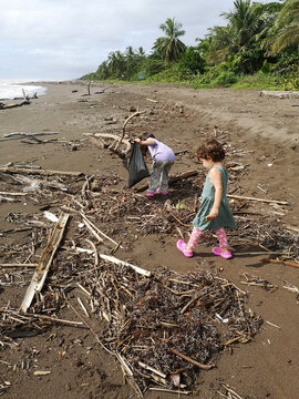 Kids doing Beach Cleanup collecting plastic UGC 