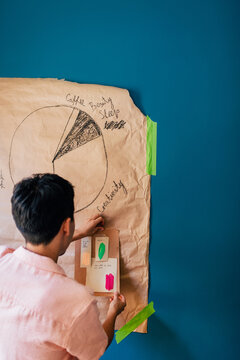 Man Hanging His Work on Wall