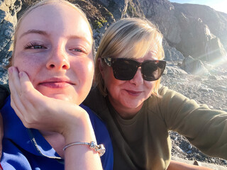 Fototapeta premium Selfie of middle-aged woman and her teenage daughter on a beach