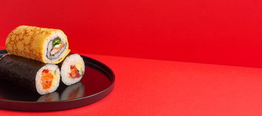 Setsubun, Japanese event. Ehomaki on red background. 節分。赤背景上の恵方巻